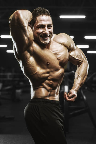 istock Handsome strong athletic men pumping up muscles workout bodybuilding concept background 1208170285