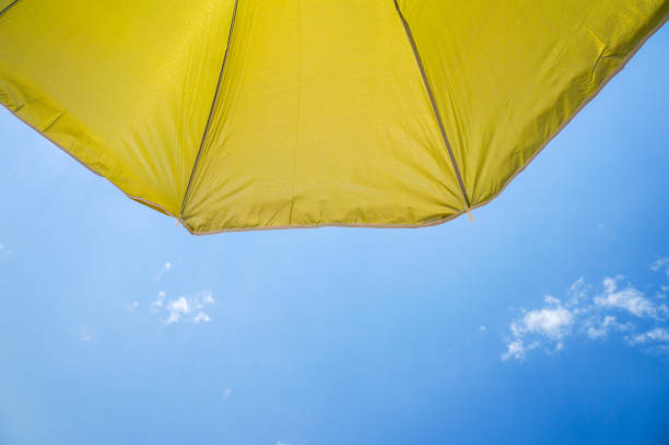 Colorful umbrella white blue sky background