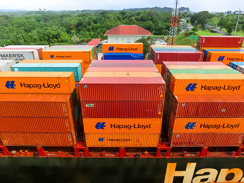 Panama Canal, Panama - December 7, 2019: Hapag-Lloyd cargo ship entering the Miraflores Locks in the Panama Canal, in Panama
