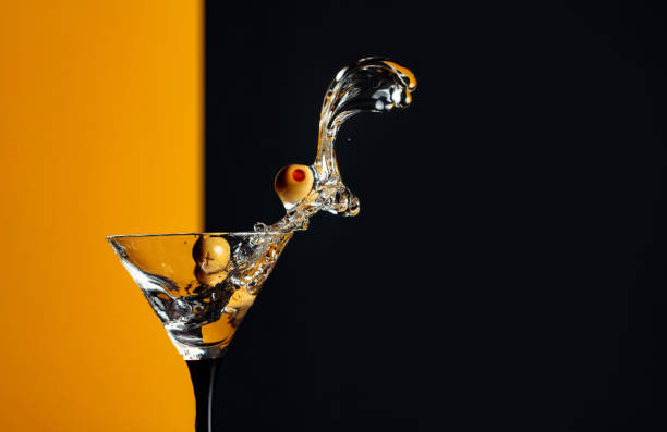 istock Martini with green olives splash. 1208171653