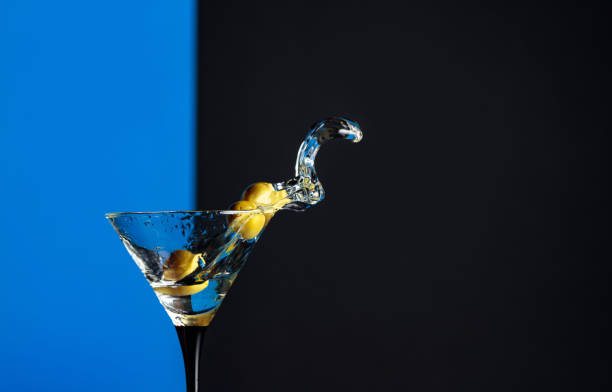 istock Martini with green olives splash. 1208171670