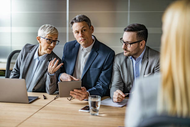 istock Human resource team using touchpad and talking to their candidate in the office. 1208172489