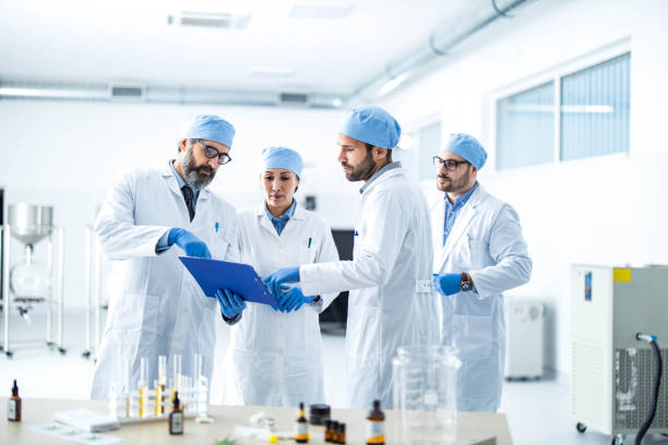 Team of scientists examining research data in laboratory.