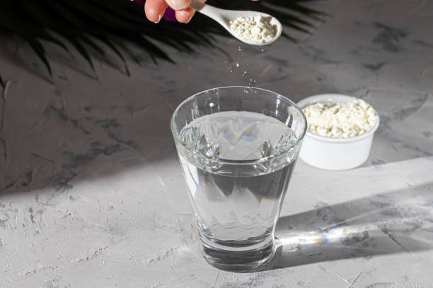 istock Collagen powder is placed in a glass with a measuring spoon. Freeze frame Additional protein intake. Natural supplements for beauty and health. Collagen based plant concept. Top view. Copy space 1208175317
