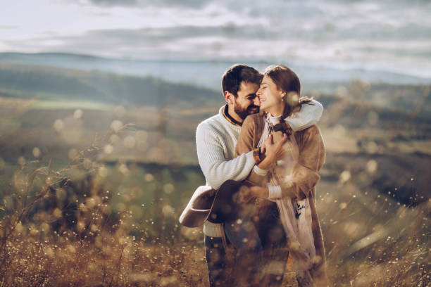 istock Happy affectionate couple embracing in autumn day in a meadow. 1208175448