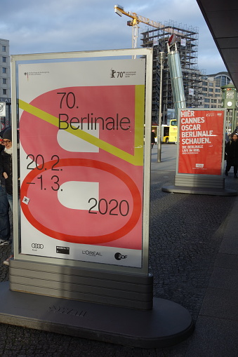 Berlin, Germany - February 22, 2020: Posters advertising the upcoming films on the Potsdamer Platz during the 70th Berlinale International Film Festival 2020 in Berlin