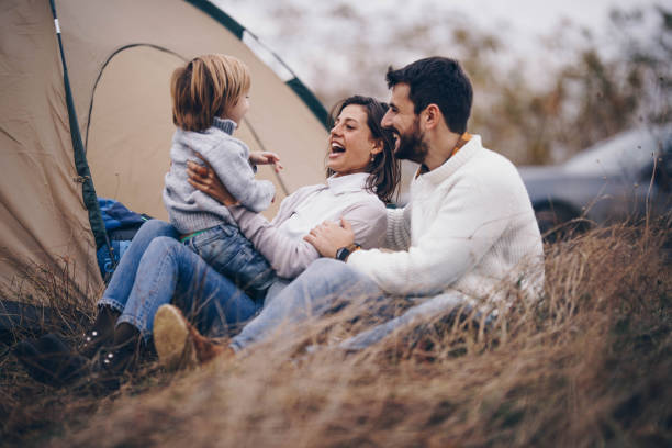 istock Happy family talking during camping day in autumn. 1208176504