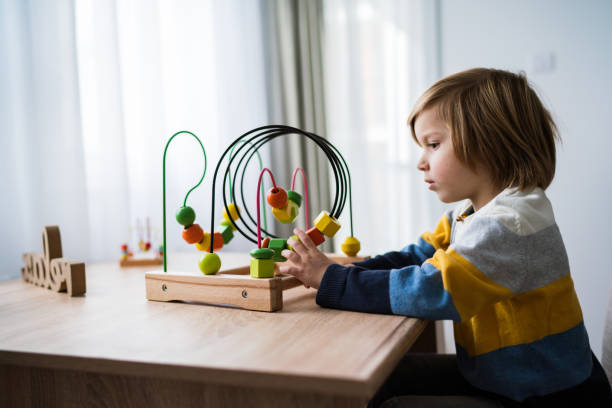 istock Boy with toy wooden maze 1208177908