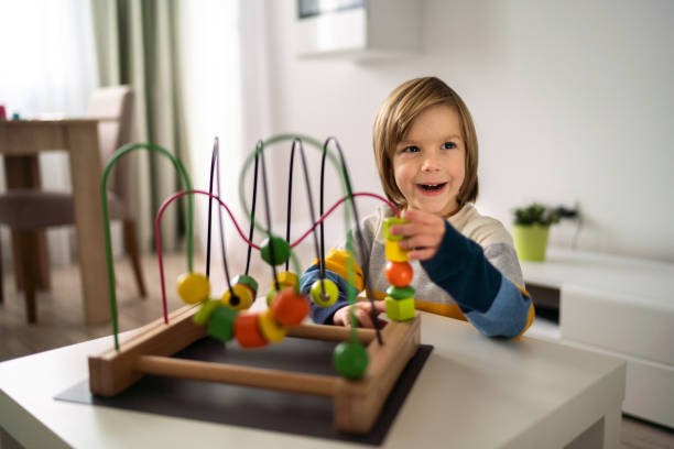 istock Boy with wooden maze toy 1208177980