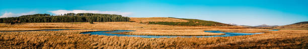 View over Colliford Lake with Brown Willy and Rough Tor hills in the distance, the highest and second highest points in Cornwall England UK