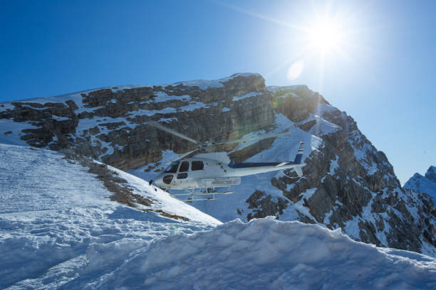 istock Heli Skiing Helicopter is landingin mountains 1208178155