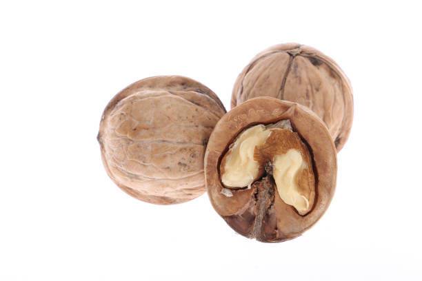istock Whole and cracked walnuts isolated on white background 1208178515