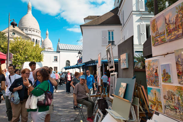 Paris, France - September 17, 2019: The Tertre square located in the heart of the Montmartre district, a place very visited by tourists, where you can find numerous restaurants and dozens of artists show their works.