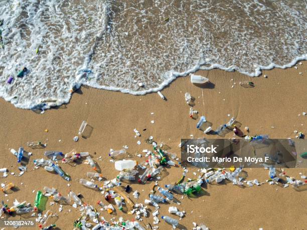 Waves Pushing Plastic Waste To The Beach Stock Photo - Download Image Now - Plastic, Sea, Plastic Pollution