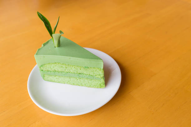 istock Close up slice of green tea cake on white dish. 1208184112