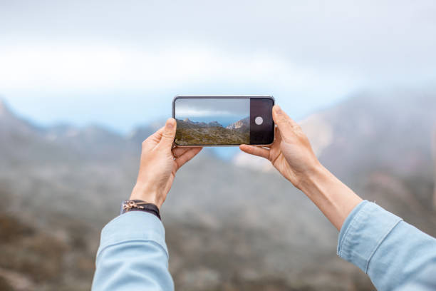 istock Photographing mountains on phone 1208189667