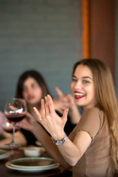 istock Beautiful young women calling her friend at restaurant 1208191304