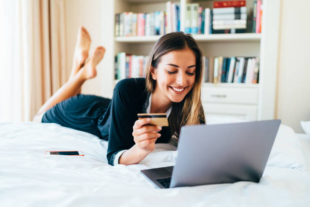 istock Woman in bed shopping online 1208191517