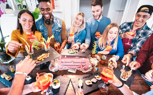 istock Friends group having fun at pre dinner party buffet drinking spr 1208195211