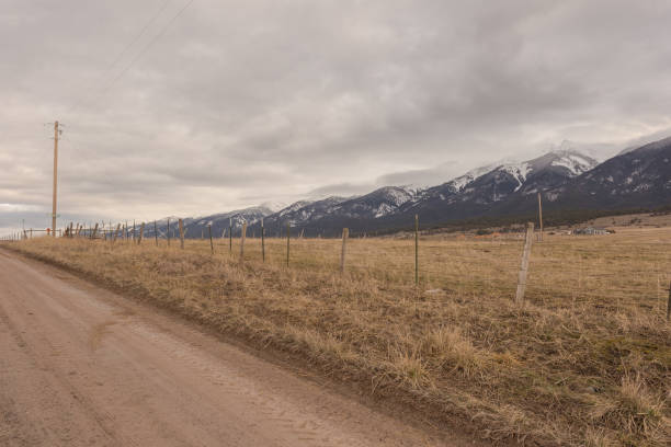 istock Telephone pole and dirt road as leading line 1208196360