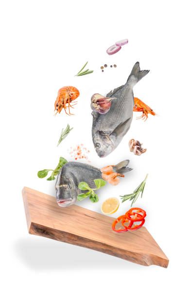 istock Flying raw whole bream fish and prawns with ingredients 1208196614