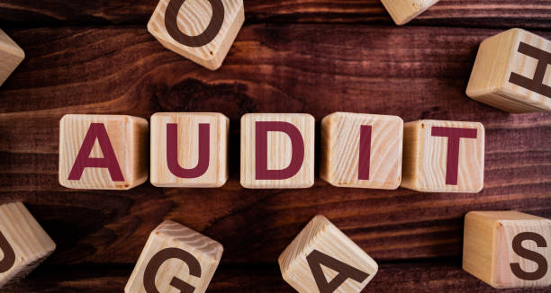 istock AUDIT word on wooden cubes on a dark wood background 1208199054