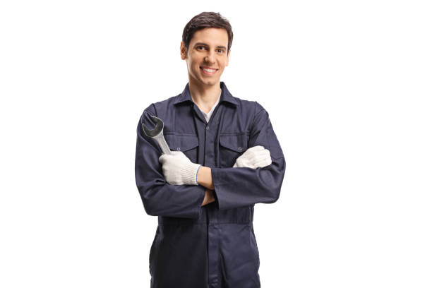 istock Young worker in a uniform holding a wrench 1208199489