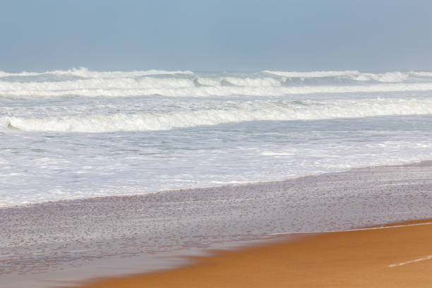 Ocean coast, moviment waves with foam. Wind power. Turquoise water.