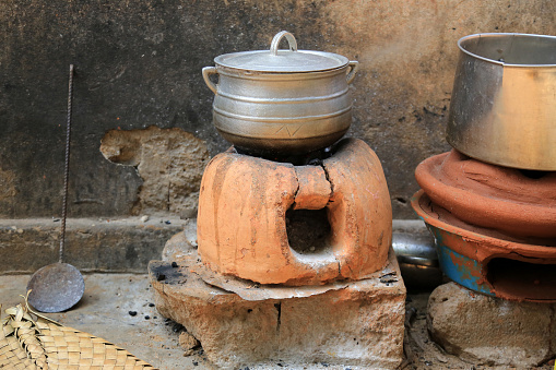West Africa. Togo. Lome. 01/02/2014. This colorful image depicts the preparation of lunch: cooking on an earthen oven.