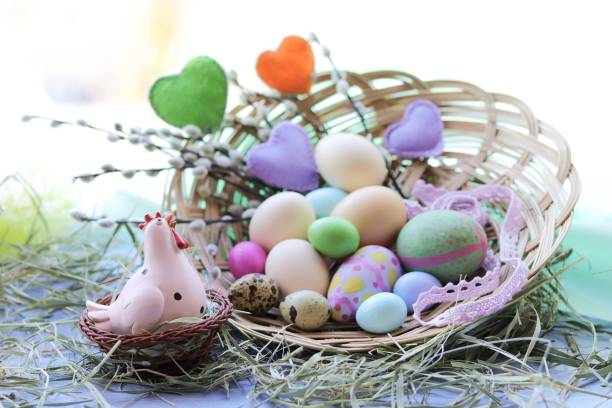 istock Happy Easter, a basket with painted eggs, a toy chicken, hay on the windowsill 1208204334