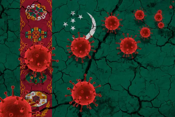 Photo of Red virus cells, pandemic influenza virus epidemic infection, coronavirus, Asian flu concept, against the background of a cracked turkmenistan flag
