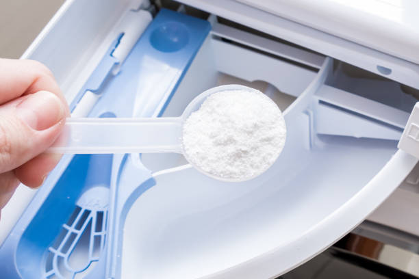 istock A housewife adding a phosphate-free detergent to a washing machine drawer. 1208206171