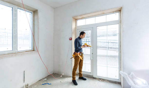 istock Worker in glazier's workshop, warehouse or storage handling glass 1208207940