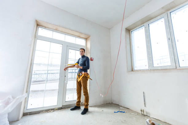 istock Worker in glazier's workshop, warehouse or storage handling glass 1208207997