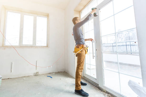 istock Worker in glazier's workshop, warehouse or storage handling glass 1208208026