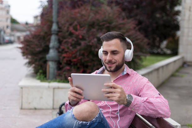 istock Man with headphones and digital tablet 1208209641