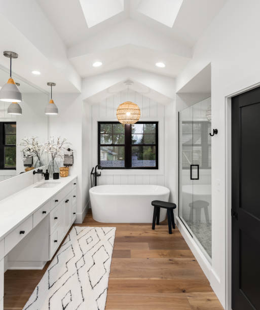Master bathroom interior in new farmhouse style luxury home large mirror, shower, and bathtub. Master bathroom with double vanity hardwood floor photos stock pictures, royalty-free photos & images