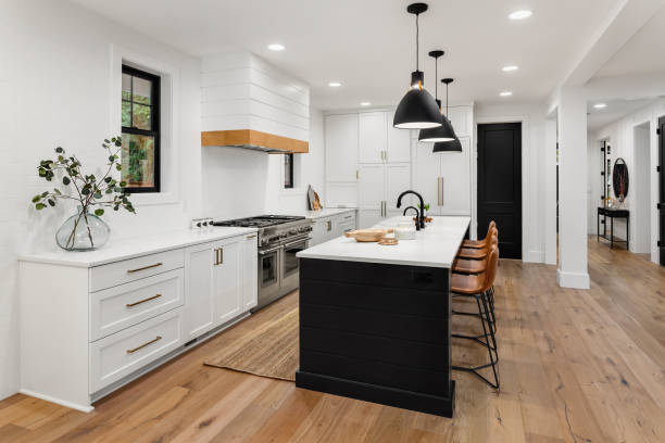 Beautiful white kitchen with dark accents in new farmhouse style luxury home kitchen in newly constructed luxury home hardwood photos stock pictures, royalty-free photos & images