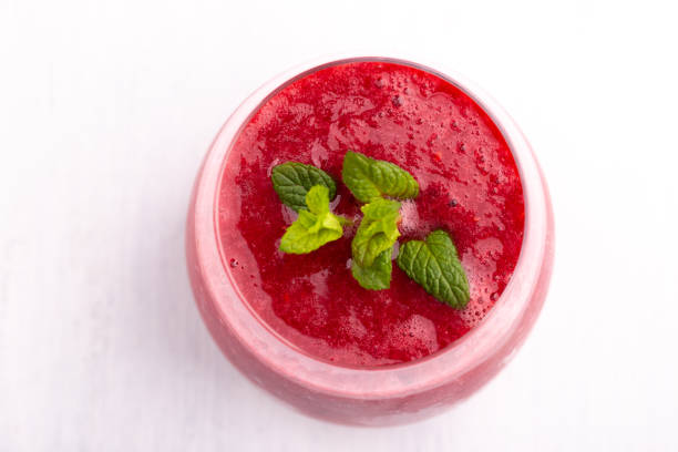 istock Glass of strawberry and raspberry smoothie 1208210913