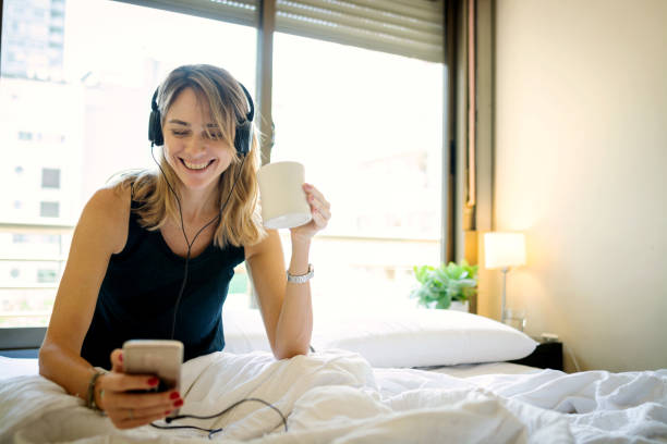 istock Woman in the morning using cell phone in the bed 1208211156