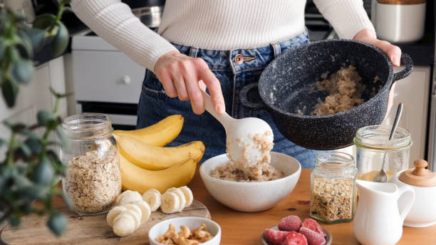 Woman putting oatmeal in a bowl
