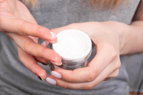 istock Woman takes finger cream from a jar 1208211969