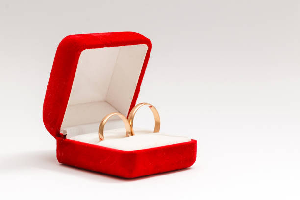 istock Two wedding rings in nice red box isolated on white background 1208212007