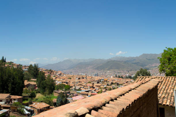 The view of Cusco City as seen from the region of San Blas, across the clay roof tiles of the famous buildings. The mountainous hills can be seen in the distance. Taken in Cusco City, Peru.