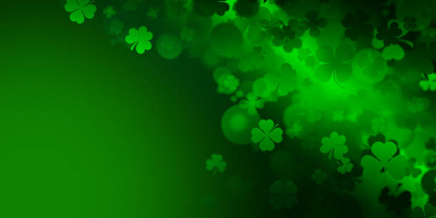 istock St Patrick's day illustration, clover leafs rotating on the green background 1208213514