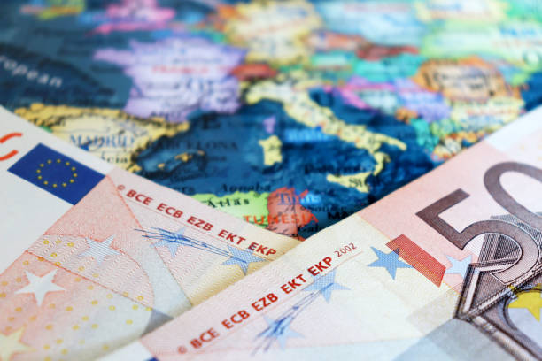 istock Euro banknotes on the map of Europe, selective focus 1208214417