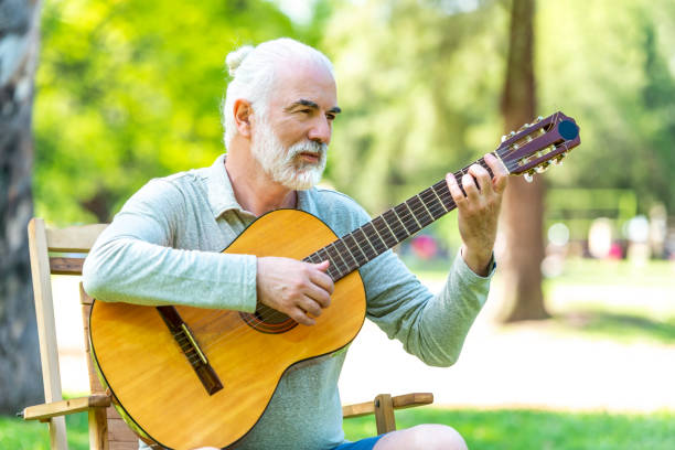 istock Senior male playing guitar 1208214652