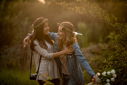 Two beautiful girls laughing outdoors