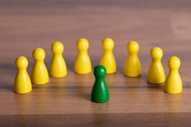 istock wooden figurine in front of group, standing for speaker before his audiance 1208215564