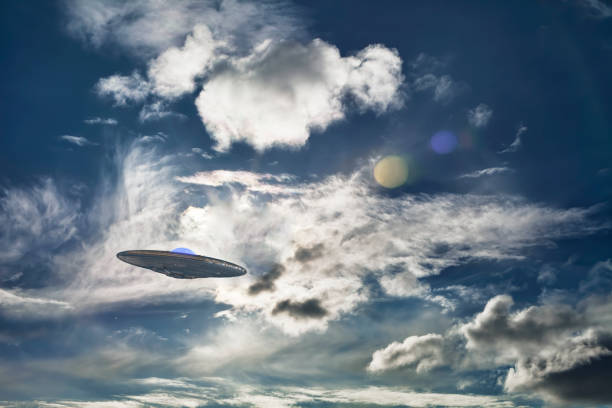 istock UFO spaceship flying in the sky with clouds and planets. 1208215636